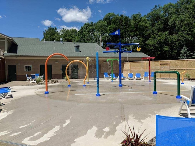 exterior space featuring fence and playground community