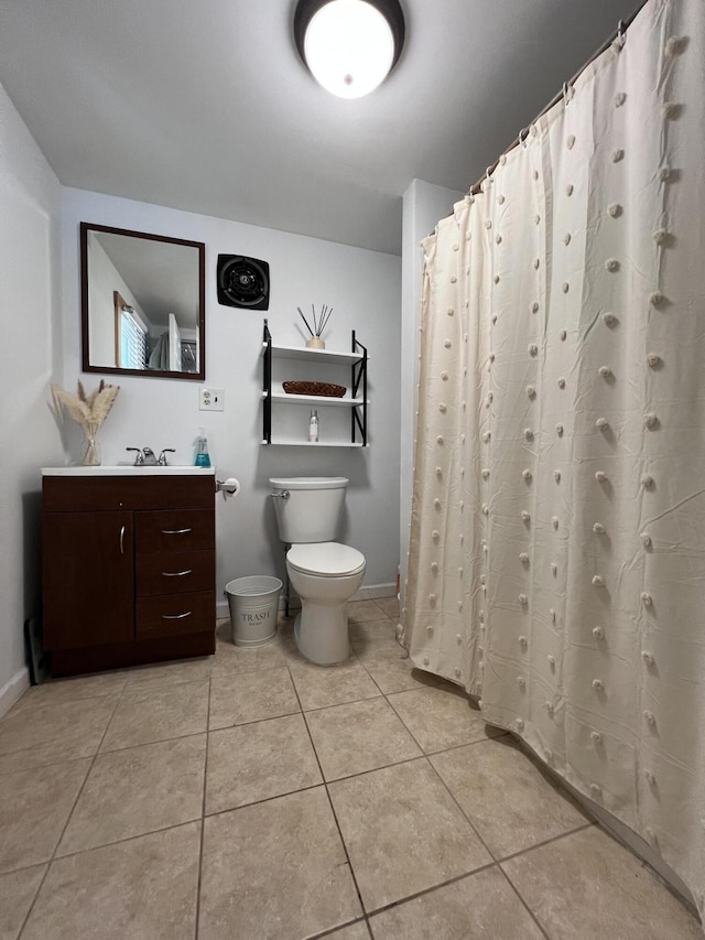 full bath featuring toilet, vanity, tile patterned floors, and baseboards