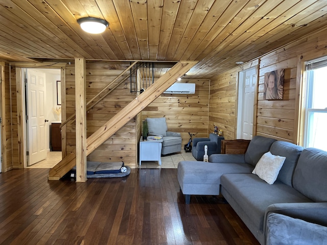 living area featuring an AC wall unit, wood walls, stairs, wood ceiling, and hardwood / wood-style flooring