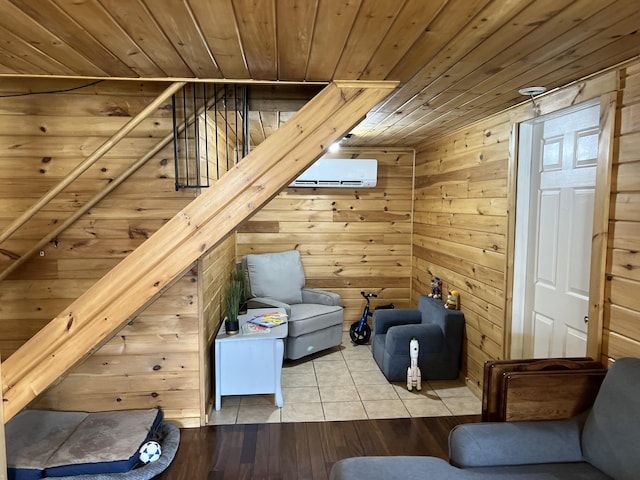 additional living space with stairway, wood walls, wood finished floors, an AC wall unit, and wooden ceiling