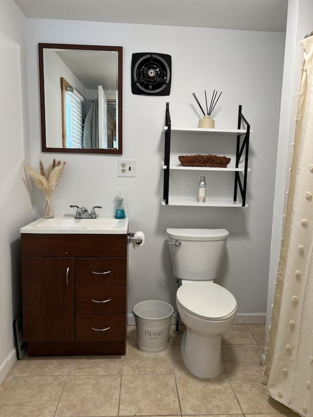 full bath with baseboards, toilet, vanity, and tile patterned floors