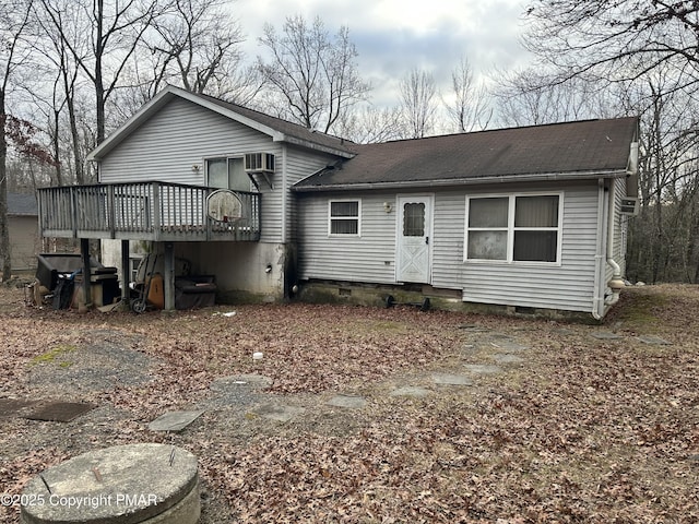 rear view of house with a wooden deck and an AC wall unit