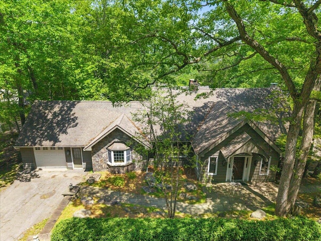 2135 Laurel Rd, Buck Hill Falls, PA 18323 - view of front facade with asphalt driveway, a garage, and stone siding