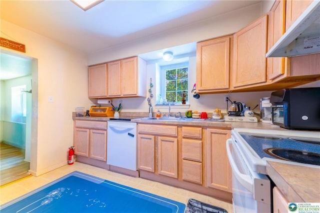 7112 Howell Ter, Stroudsburg, PA 18360 - kitchen with white appliances, under cabinet range hood, light brown cabinets, and light countertops