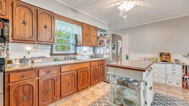 2125 Sassafras Ln, Kunkletown, PA 18058 - kitchen with crown molding, stainless steel refrigerator with ice dispenser, brown cabinets, a ceiling fan, and light tile patterned floors