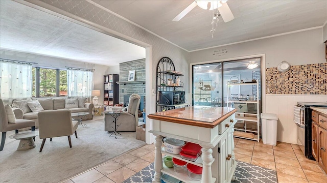 2125 Sassafras Ln, Kunkletown, PA 18058 - kitchen with light tile patterned flooring, ceiling fan, ornamental molding, white cabinetry, and light carpet
