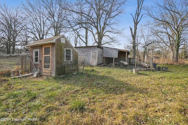 view of outbuilding featuring fence