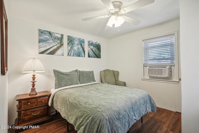 bedroom with cooling unit, wood finished floors, and a ceiling fan