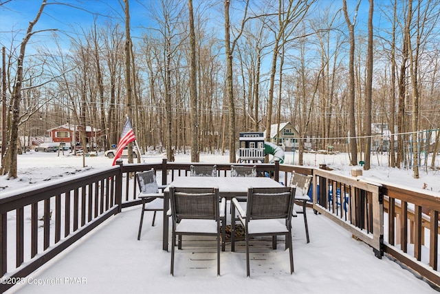 snow covered deck with a playground