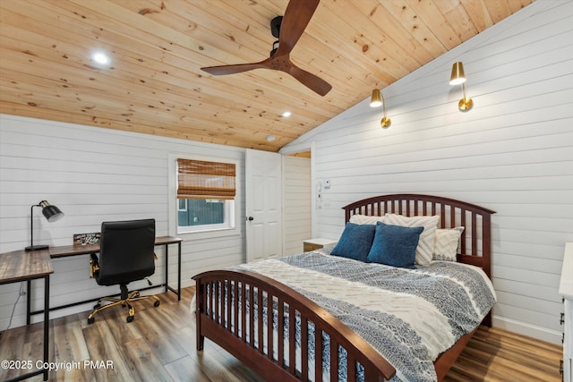 bedroom with lofted ceiling, wooden walls, hardwood / wood-style floors, and wooden ceiling