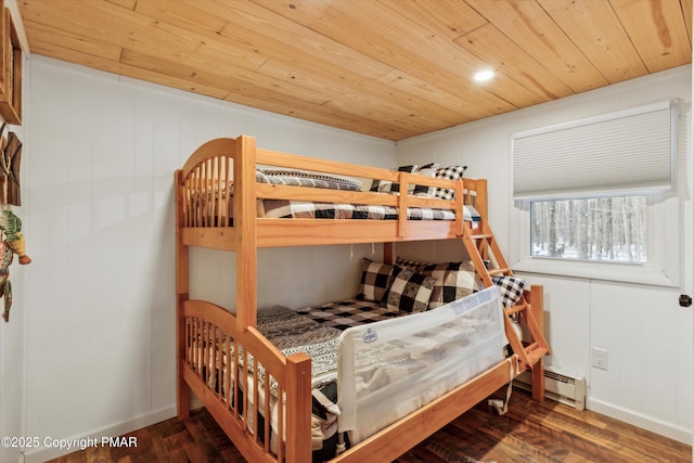 bedroom featuring baseboard heating, wood ceiling, baseboards, and wood finished floors