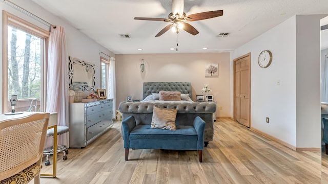 bedroom with multiple windows, baseboards, visible vents, and light wood-type flooring