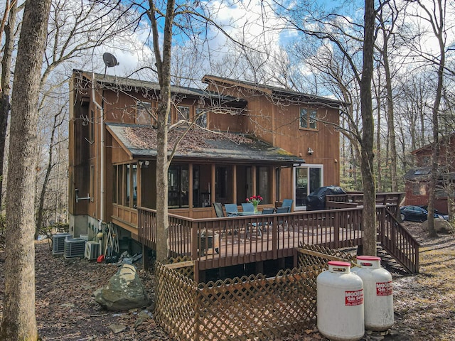 rear view of house featuring a wooden deck