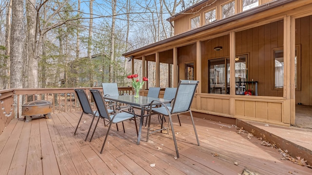 wooden terrace featuring outdoor dining area