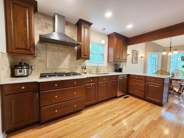 5228 Hilltop Cir E, Stroudsburg, PA 18301 - kitchen featuring wall chimney range hood, a sink, appliances with stainless steel finishes, light wood-type flooring, and a peninsula