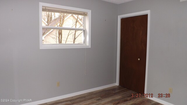 spare room with dark hardwood / wood-style flooring