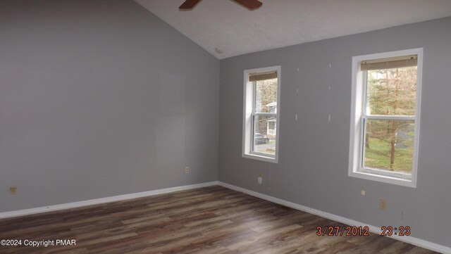 spare room with lofted ceiling, dark hardwood / wood-style flooring, a wealth of natural light, and ceiling fan