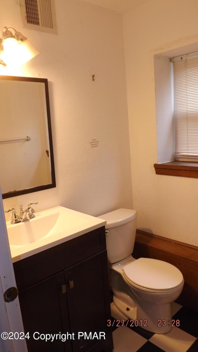 bathroom featuring vanity and toilet