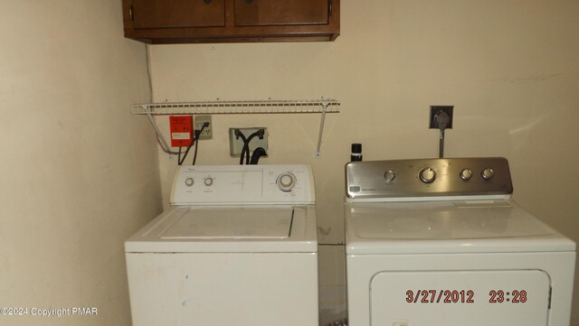 laundry room featuring cabinets and separate washer and dryer