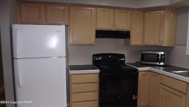 kitchen with white refrigerator and electric range