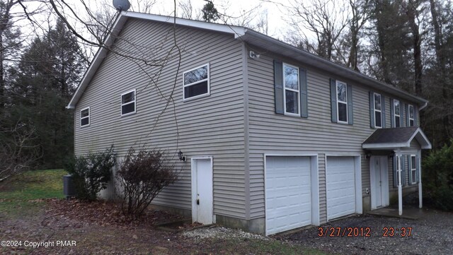 view of side of property with a garage