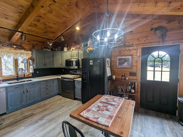 kitchen with wood ceiling, stainless steel microwave, range with electric stovetop, black refrigerator with ice dispenser, and a sink