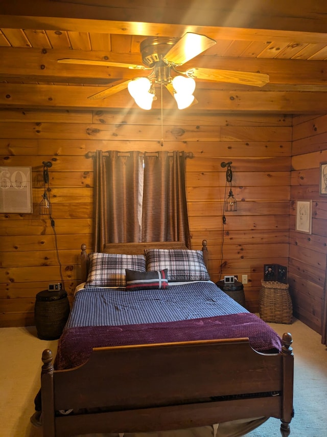 bedroom with wooden ceiling, wooden walls, and carpet