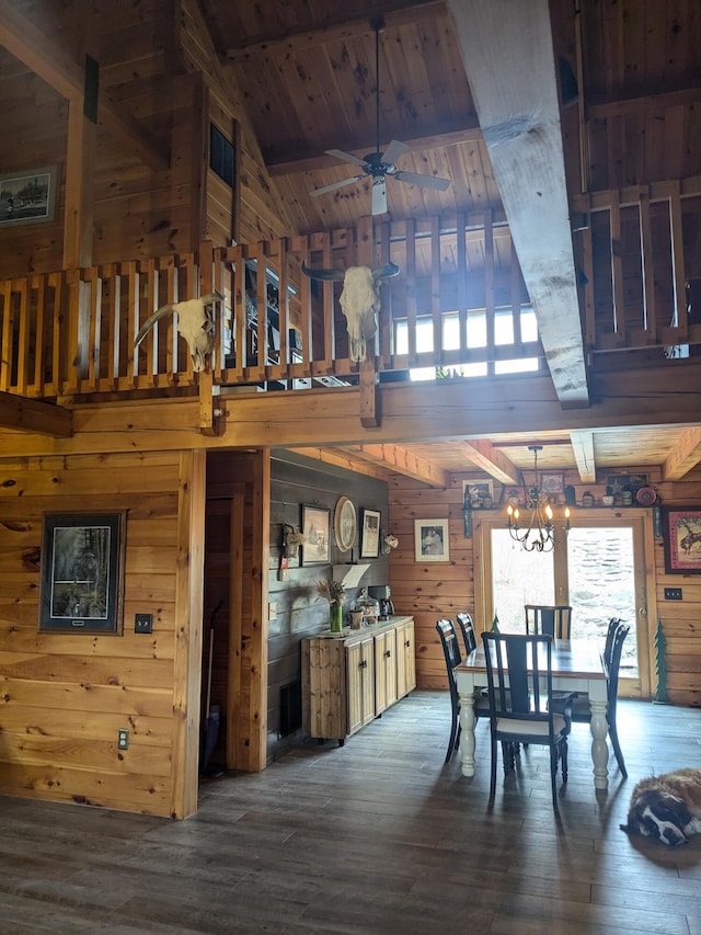dining area featuring an inviting chandelier, wooden ceiling, wood-type flooring, vaulted ceiling with beams, and wood walls
