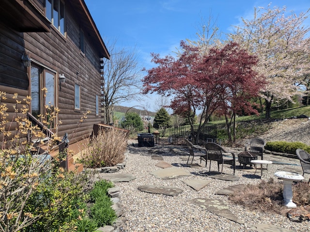 view of yard with a patio and an outdoor fire pit