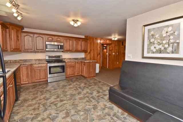 2115 Upper Smith Gap Rd, Saylorsburg, PA 18353 - kitchen featuring stainless steel appliances, stone flooring, brown cabinets, and stone countertops