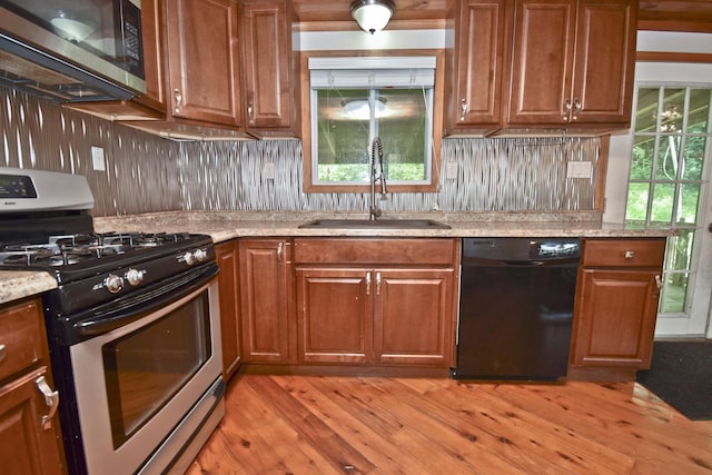 2115 Upper Smith Gap Rd, Saylorsburg, PA 18353 - kitchen with appliances with stainless steel finishes, light wood-type flooring, brown cabinetry, and decorative backsplash