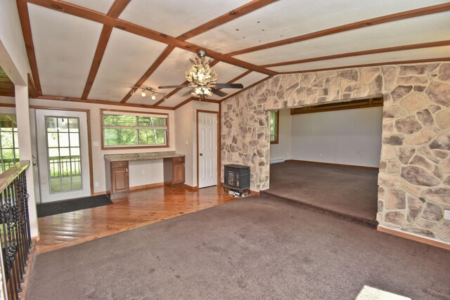 2115 Upper Smith Gap Rd, Saylorsburg, PA 18353 - unfurnished living room featuring carpet floors, a wood stove, ceiling fan, and wood finished floors