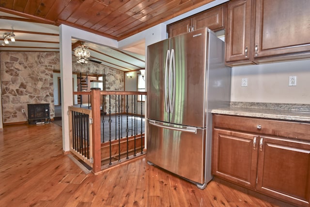 2115 Upper Smith Gap Rd, Saylorsburg, PA 18353 - kitchen featuring freestanding refrigerator, wood ceiling, light wood-style floors, ceiling fan, and a wood stove