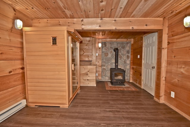 2115 Upper Smith Gap Rd, Saylorsburg, PA 18353 - unfurnished living room with baseboard heating, wood walls, wood finished floors, a wood stove, and wood ceiling