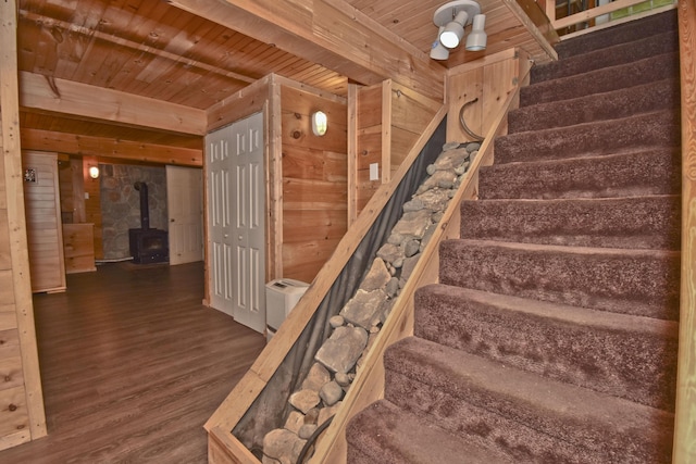 2115 Upper Smith Gap Rd, Saylorsburg, PA 18353 - staircase featuring wood walls, a wood stove, wood finished floors, and a wooden ceiling with exposed beams