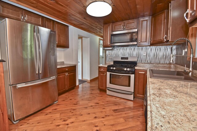 2115 Upper Smith Gap Rd, Saylorsburg, PA 18353 - kitchen with appliances with stainless steel finishes, wooden ceiling, light wood-style flooring, decorative backsplash, and light stone countertops