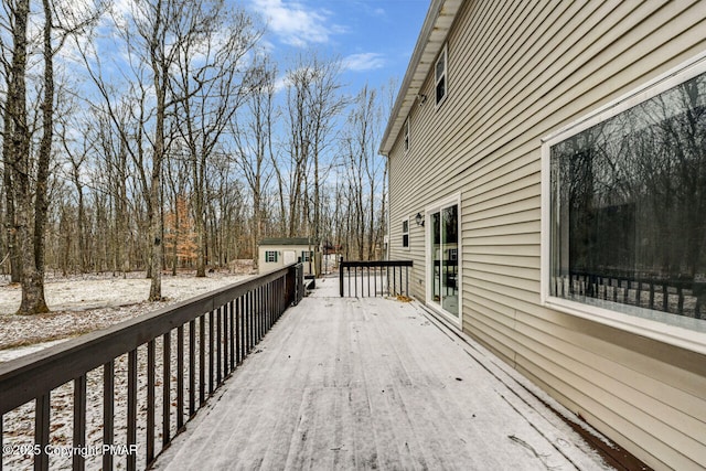 snow covered deck with an outbuilding