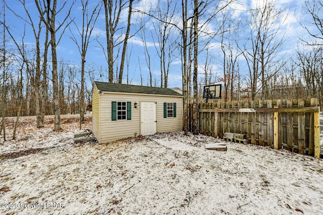 view of outbuilding featuring fence and an outdoor structure