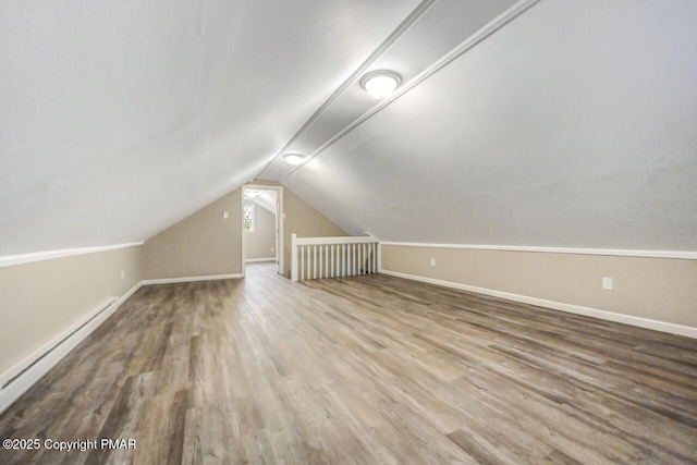 bonus room featuring vaulted ceiling, a baseboard radiator, wood finished floors, and baseboards