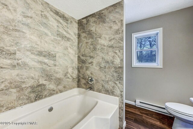 bathroom with baseboard heating, wood-type flooring, toilet, and vanity