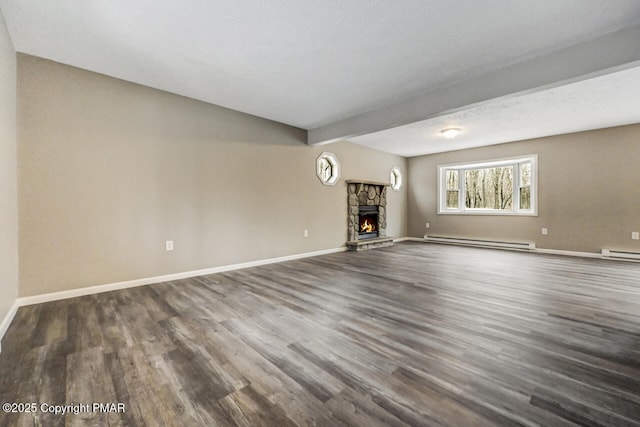 unfurnished living room with dark wood-type flooring, a stone fireplace, a baseboard radiator, and beamed ceiling