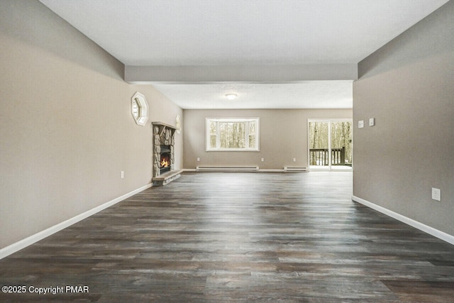 unfurnished living room with dark wood-type flooring, a fireplace, and a baseboard radiator