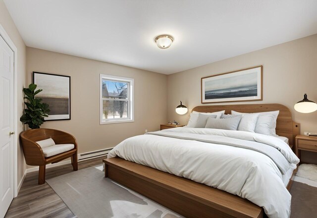 unfurnished bedroom featuring ensuite bathroom, a spacious closet, light hardwood / wood-style floors, and a textured ceiling