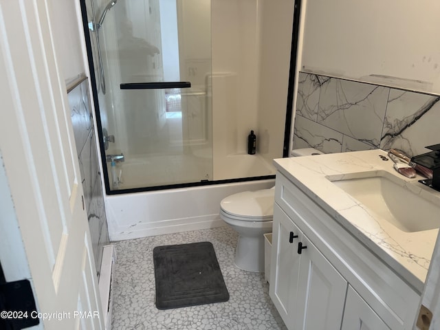 bathroom with tile walls, combined bath / shower with glass door, vanity, and toilet