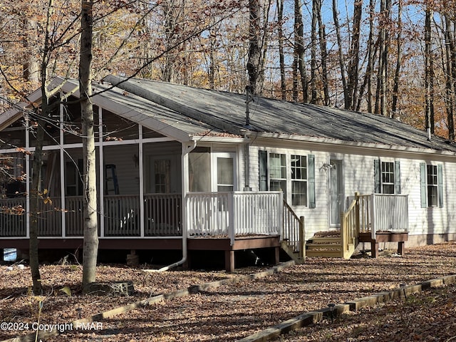 view of front of property with a sunroom and metal roof