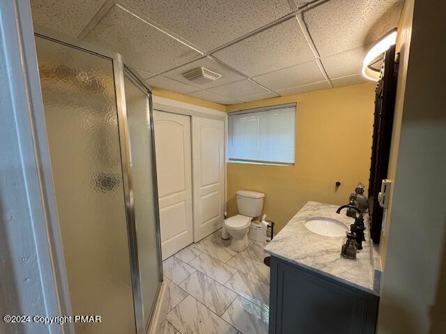 full bathroom with marble finish floor, vanity, a shower stall, and visible vents