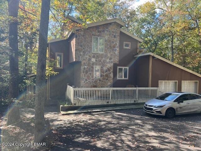 view of front of house featuring a garage and stone siding