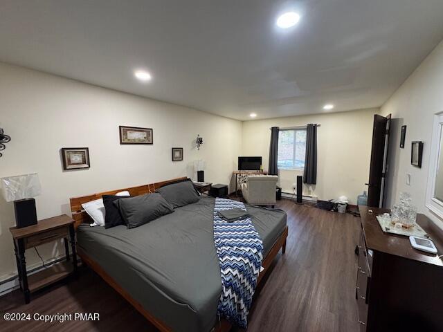 bedroom featuring dark wood-style floors and recessed lighting