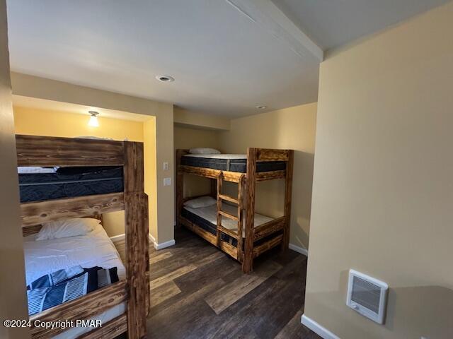 bedroom featuring dark wood-style flooring and baseboards