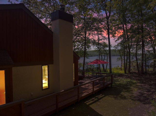 99 Ruffed Grouse Ct, Lake Harmony, PA 18624 - view of side of home with a chimney, a deck with water view, and stucco siding